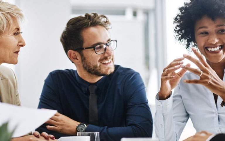  group of agreeable people sitting together in a meeting