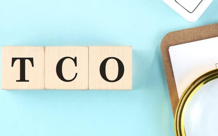 TCO on blocks next to clipboard with numbers in chart