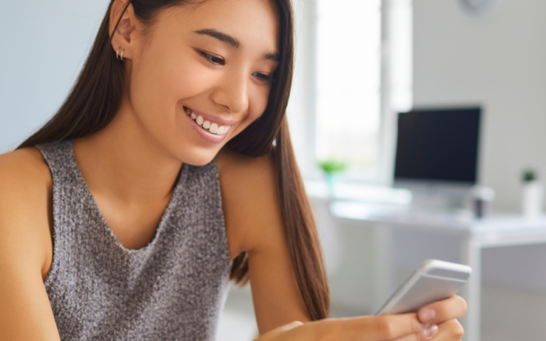 woman smiling at phone