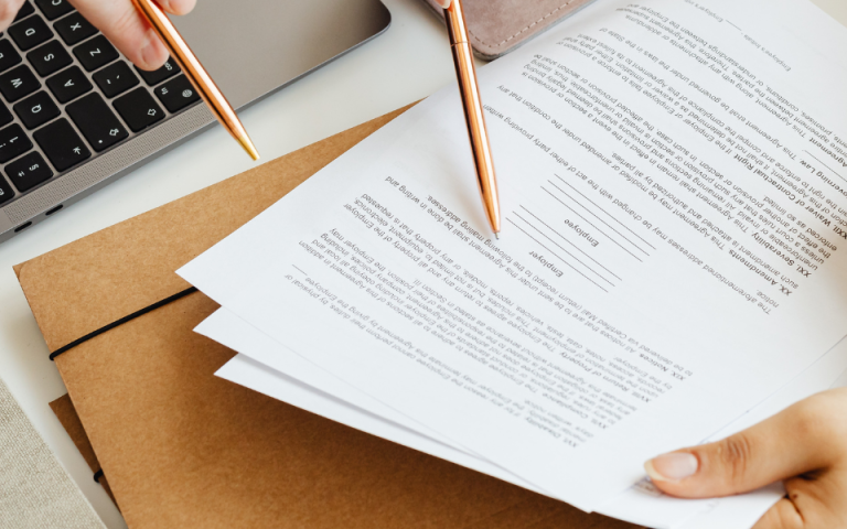 people looking at printed document