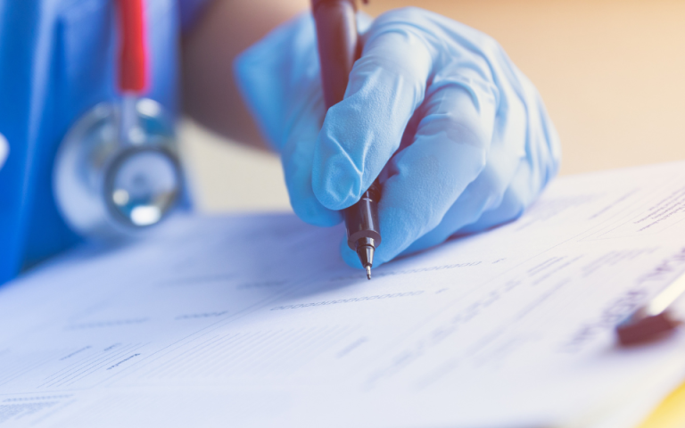 healthcare working writing on paper