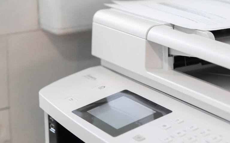 two large printers with blank screens