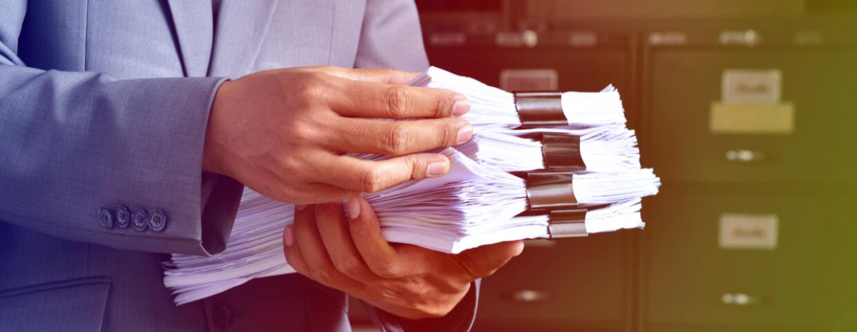 Man holding stack of documents