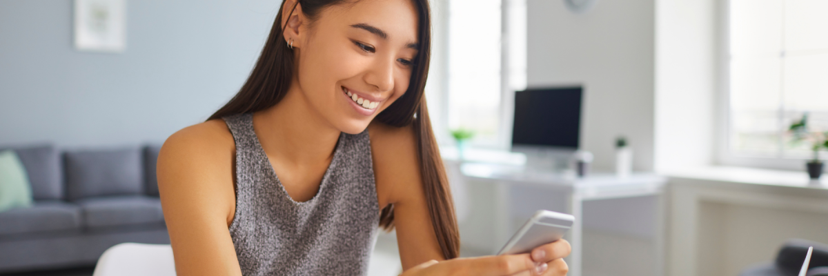 woman smiling at phone