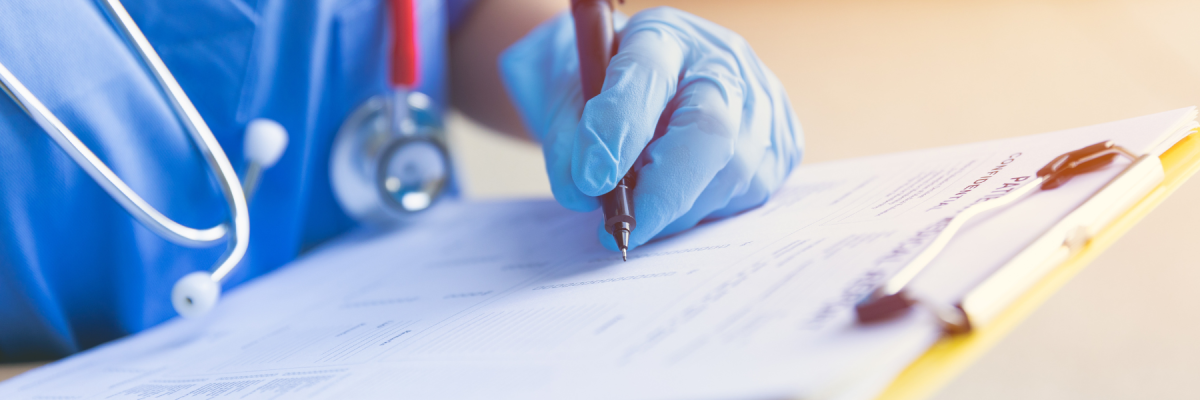 healthcare working writing on paper