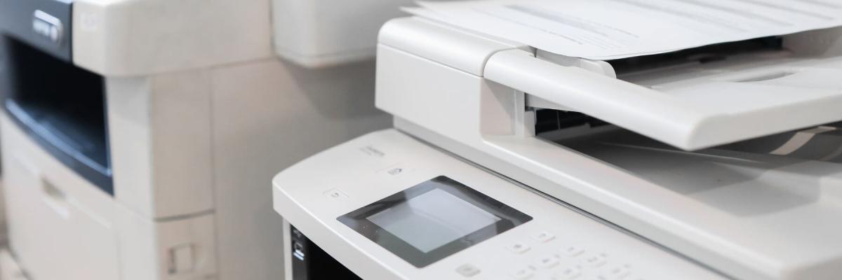 two large printers with blank screens