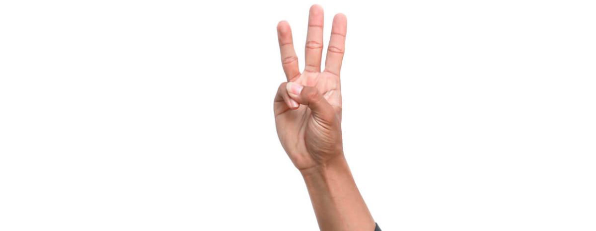 Hand holding up three fingers